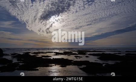 Sunset cloudy sky over the coast line. Stock Photo