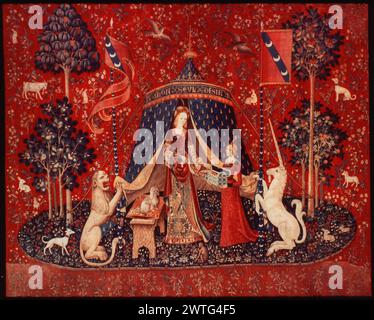 À mon seul désir. unknown c. 1490-1500 Tapestry Dimensions: H 12' x W 10'6' Tapestry Materials/Techniques: wool & silk Culture: Southern Netherlands Ownership History: Boussac Château, near Aubusson. Acquired by the Cluny Museum, 1882. France, Paris, Paris, Musée de Cluny, accno. Cl. 10834. Inscriptions: At top of tent: A MON SEUL DESIR Richly gowned lady, flanked by lion & unicorn, standing before tent, placing (or taking ?) necklace in treasure box held by maiden, dark blue oval island & red background with millefleurs motif The 'Lady with unicorn' series may have been commissioned by Jean I Stock Photo