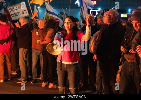 Tel Aviv, Israel. 16th Mar, 2024. A protester chants slogans megaphone during a demonstration. Two protests merge outside the Kirya military headquarters in Tel Aviv. One called for immediate elections to oust Netanyahu, the other calling for the release of the hostages still being held by Hamas. Credit: SOPA Images Limited/Alamy Live News Stock Photo