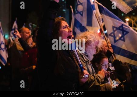 Tel Aviv, Israel. 16th Mar, 2024. A protester shouts during the demonstration. Two protests merge outside the Kirya military headquarters in Tel Aviv. One called for immediate elections to oust Netanyahu, the other calling for the release of the hostages still being held by Hamas. Credit: SOPA Images Limited/Alamy Live News Stock Photo