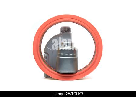 Grey plastic oil canister, orange air filter and silver metal oil filter isolated on white background, suggesting vehicle maintenance or part replacem Stock Photo