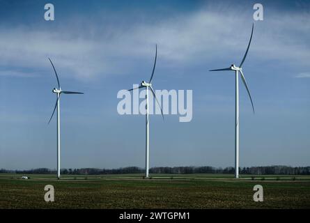Three wind turbines on field Stock Photo