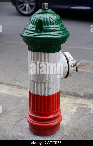 A green, white and red fire hydrant on a New York pavement, Manhattan, New York City, New York, USA, North America Stock Photo