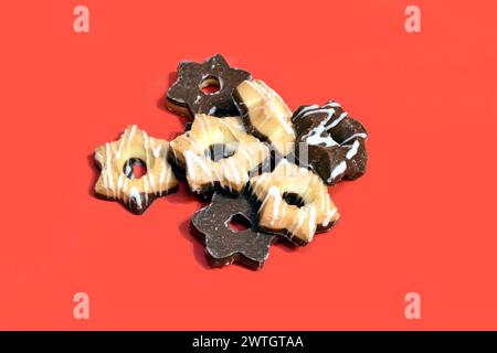 Cookies made with the addition of cocoa lie on a pink background. Cookies of two colors and tastes. Stock Photo