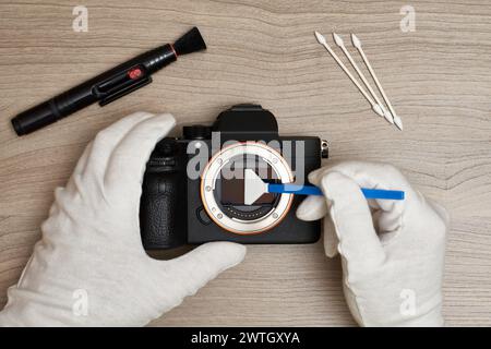 Cleaning a modern digital full-frame camera sensor using a sensor swab Stock Photo