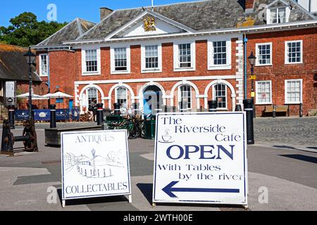 Front view of the Custom House (now a visitor centre) along the waterfront with signs in the foreground, Exeter, Devon, UK, Europe. Stock Photo