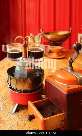Two cups of espresso being brewed with a small retro style coffee maker Stock Photo