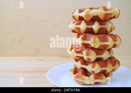 Plate of Tasty Belgian Waffles Stack on Wooden Table Stock Photo