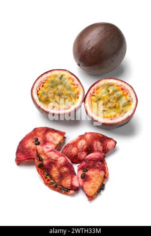 Halved fresh passion fruit and dried  preserved passion fruit close up isolated on white background Stock Photo