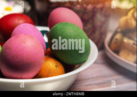 Painted eggs on the Easter holiday table. Easter brunch with eggs and pastries on the holiday table. Stock Photo