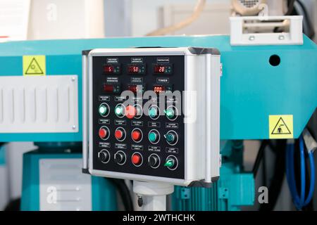 Industrial control console with switches, push buttons and digital controllers. Selective focus. Stock Photo