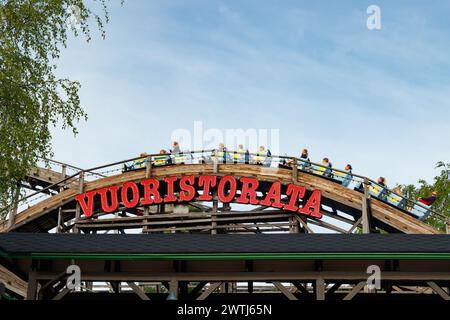 Helsinki, Finland - 21 May 2023: Ride roller coaster Vuoristorata in motion on sky background in amusement park Linnanmaki Stock Photo