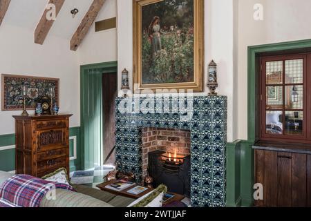 Lit stove in tiled firaplace in luxury hotel in Ardfin on the Isle of Jura, Inner Hebrides, Scotland, UK Stock Photo