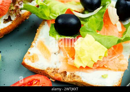 Appetizing sandwiches with salted salmon fish for breakfast. Open toasts. Stock Photo