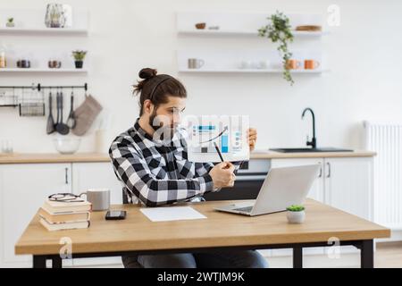 Caucasian worker providing statistical analysis using modern technologies. Stock Photo