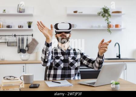 Caucasian worker testing VR headset while sitting at wooden table. Stock Photo