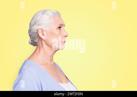 Side profile view portrait of beautiful nice content serious gray-haired old lady wearing casual. Isolated over pastel violet purple background Stock Photo