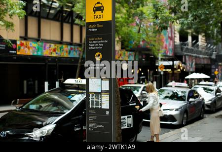 Sydney, Australia. 18th Mar, 2024. A woman gets on a taxi at a taxi rank in Sydney, Australia, March 18, 2024. After a five-year class action, the ride-sharing giant Uber has agreed to pay 272 million Australian dollars (about 178.5 million U.S. dollars) to compensate taxi drivers in the country for operating services without being licensed. Credit: Ma Ping/Xinhua/Alamy Live News Stock Photo