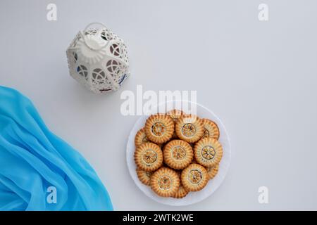 Top view of eid sweets and fanos on white table Stock Photo