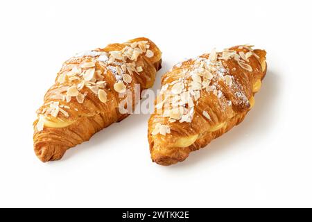 Dive into the delightful pairing of two croissants filled with aromatic vanilla cream and adorned with crunchy almond flakes, presented against a pris Stock Photo