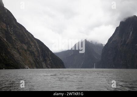 Part of the spectacular Milford Sound, one of the wettest places on the planet, is seen under typically heavy skies over Fiordland, New Zealand. Stock Photo