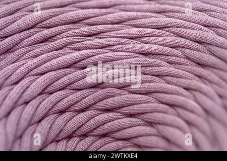 Skein of pink braided synthetic cord, close-up shot, selective focus, abstract textile industry background Stock Photo