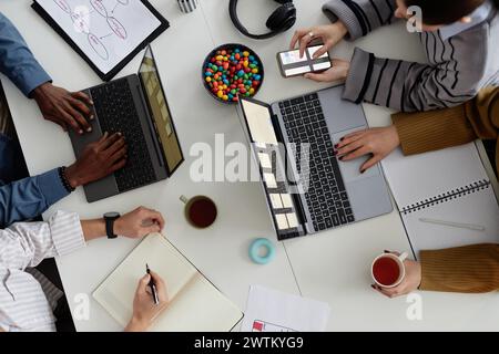 Top view background image of creative design team using laptop at meeting table Stock Photo
