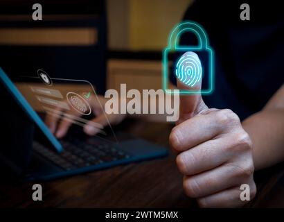 Blue fingerprint scan and lock icon on laptop computer screen while ...