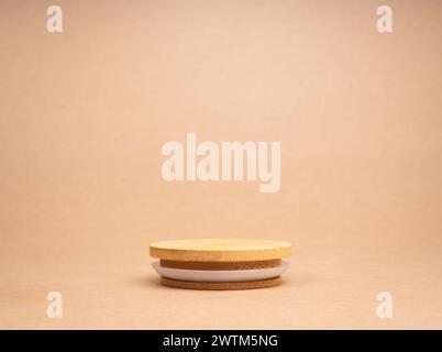 Round wooden stack as a podium with empty space for place food, cosmetics products designs isolated on recycle paper background. Mockup display on bro Stock Photo