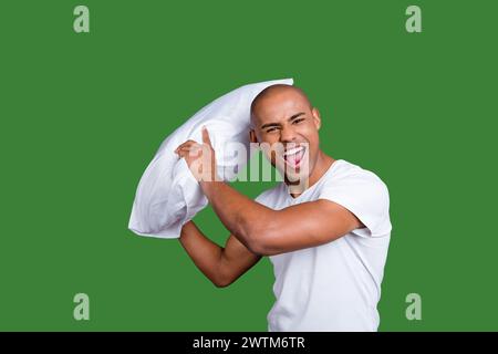 Close up photo strong healthy dark skin he him his macho bald head yell hold pillow ready for battle play playful like child wearing white t-shirt Stock Photo