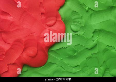 A background texture made out of red and green play clay. Close up. Stock Photo