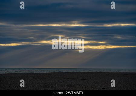 Sunbeams behind storm clouds at Dungeness Stock Photo