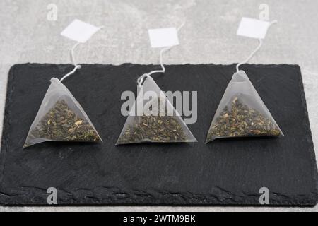 Triangular teabag with tea on a slate Stock Photo