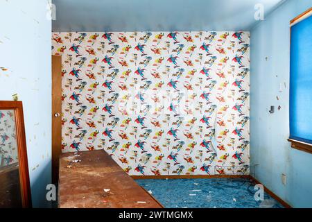 Retro 80s superhero wallpaper in a blue bedroom. Stock Photo