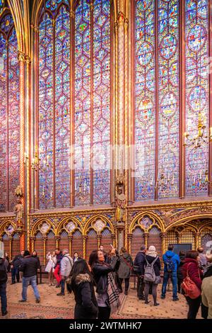 Tourists admire the stunning stained glass windows at the Sainte Chapelle. Stock Photo