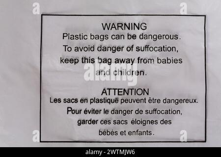 Warning plastic bags can be dangerous To avoid danger of suffocation keep this bag away from babies and children detail on plastic bag French English Stock Photo