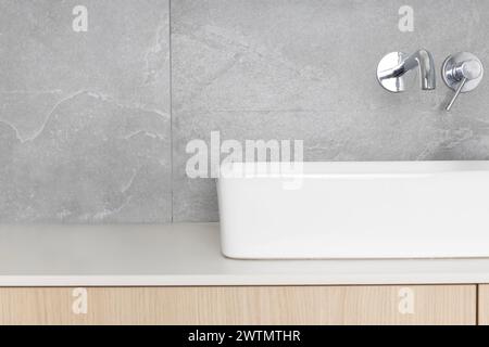 Sleek Modern Bathroom Sink with Wall-Mounted Faucet Stock Photo