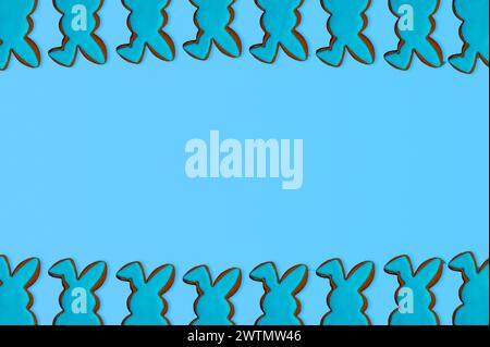 Bunny shaped cookies on pastel blue background. Easter gingerbread cookie. Happy Easter day. Stock Photo