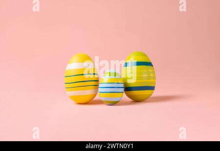 Minimal Easter layout with colorful eggs on a pink background. Easter family eggs . creative concepts. Easter card with copy space for text Stock Photo