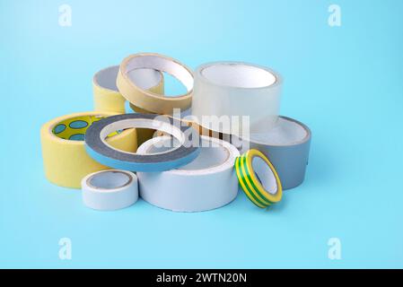 many different kind of scotch tapes on a blue background. Stock Photo