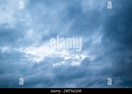 Black cloud and thunderstorm before rainy, Dramatic blue clouds and dark sky. Stock Photo