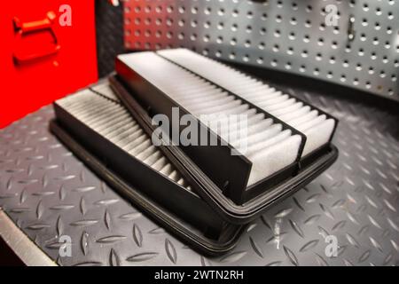 Changing a dirty engine air filter. Stock Photo