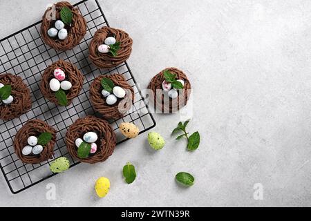 Easter chocolate cookies. Nests with sweet eggs on white background with mint leaves Stock Photo