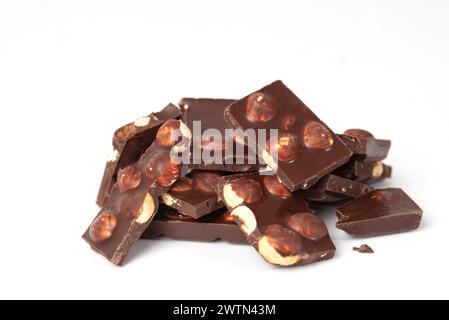 pieces of chocolate with nuts close-up isolated on white background. place for text. Stock Photo