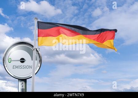 German flag flutters on the background of Gauge with inscription EMISSION. Arrow points to zero. Stock Photo