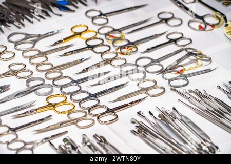 Set of many different scissors for manicure. Metal scissors on a white background. Close-up.. Stock Photo