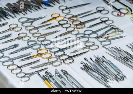 Set of many different scissors for manicure. Metal scissors on a white background. Close-up.. Stock Photo