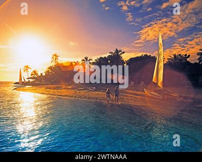 Fiji. Tropical beach sunset with couple on vacation. Stock Photo