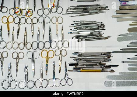 Set of many different scissors for manicure. Metal scissors on a white background. Close-up.. Stock Photo