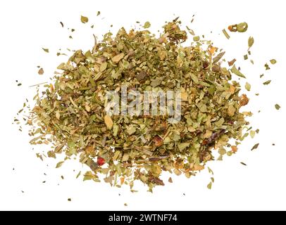 Chopped dry leaves of basil, parsley, dill and sun dried tomatoes on an isolated background. View from above Stock Photo